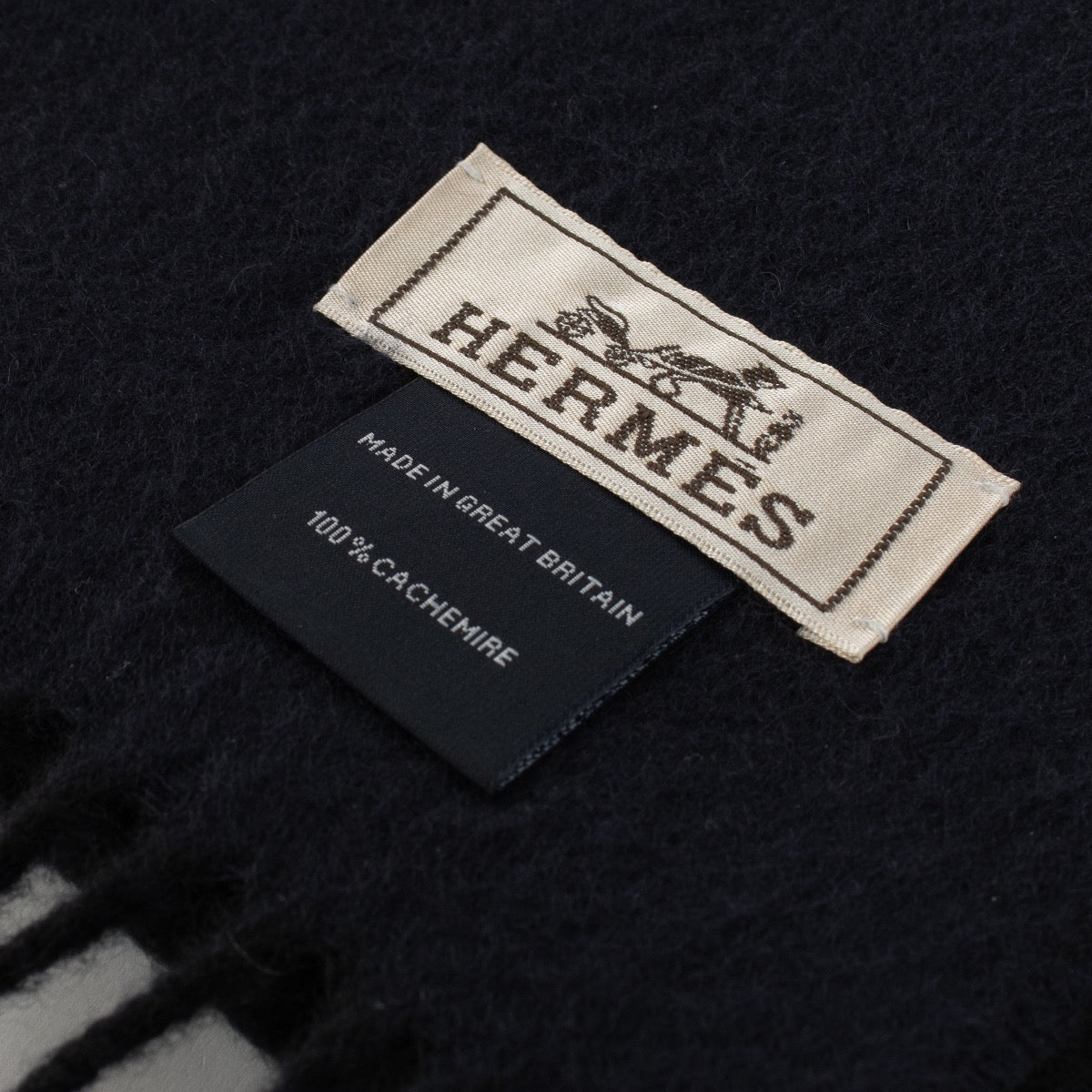 Are you looking for an authentic designer accessory? We buy and sell your preloved and brand new Hermès Recto-Verso Black/BLue Cashmere Scarf.