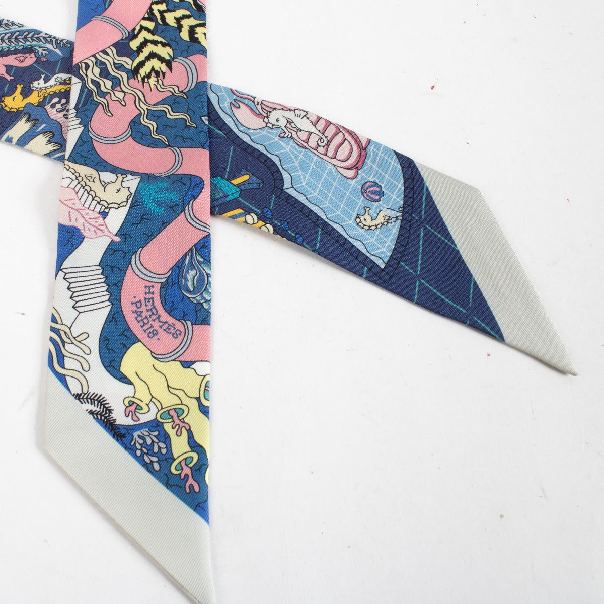 Are you looking for an authentic designer accessory? We buy and sell your preloved and brand new Hermès Blue Splash Park Twilly Scarf