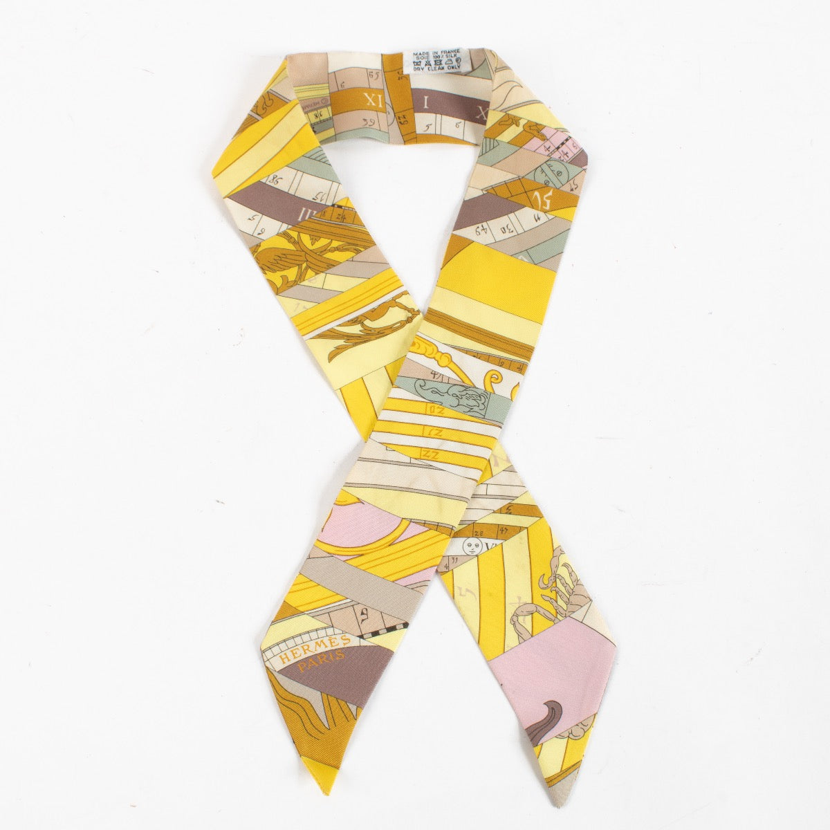 Are you looking for an authentic designer accessory? We buy and sell your preloved and brand new Hermès Yellow Astrologie Nouvelle Twilly Scarf.