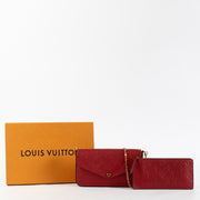 Red Louis Vuitton Monogram Empreinte Pochette Félicie wallet-on-chain with gold chain strap.