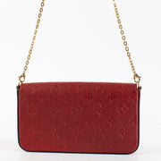 Red Louis Vuitton Monogram Empreinte Pochette Félicie wallet-on-chain with gold chain strap.