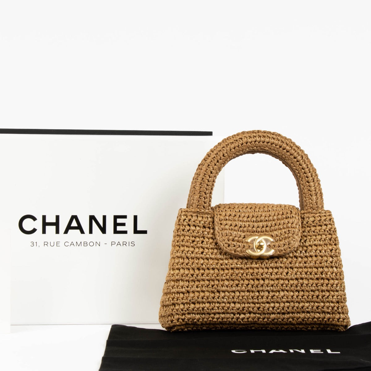 Shop safe online at Labellov in Antwerp, Brussels and Knokke this 100% authentic second hand Chanel Dark Beige Braided Raffia Kelly Nano Bag