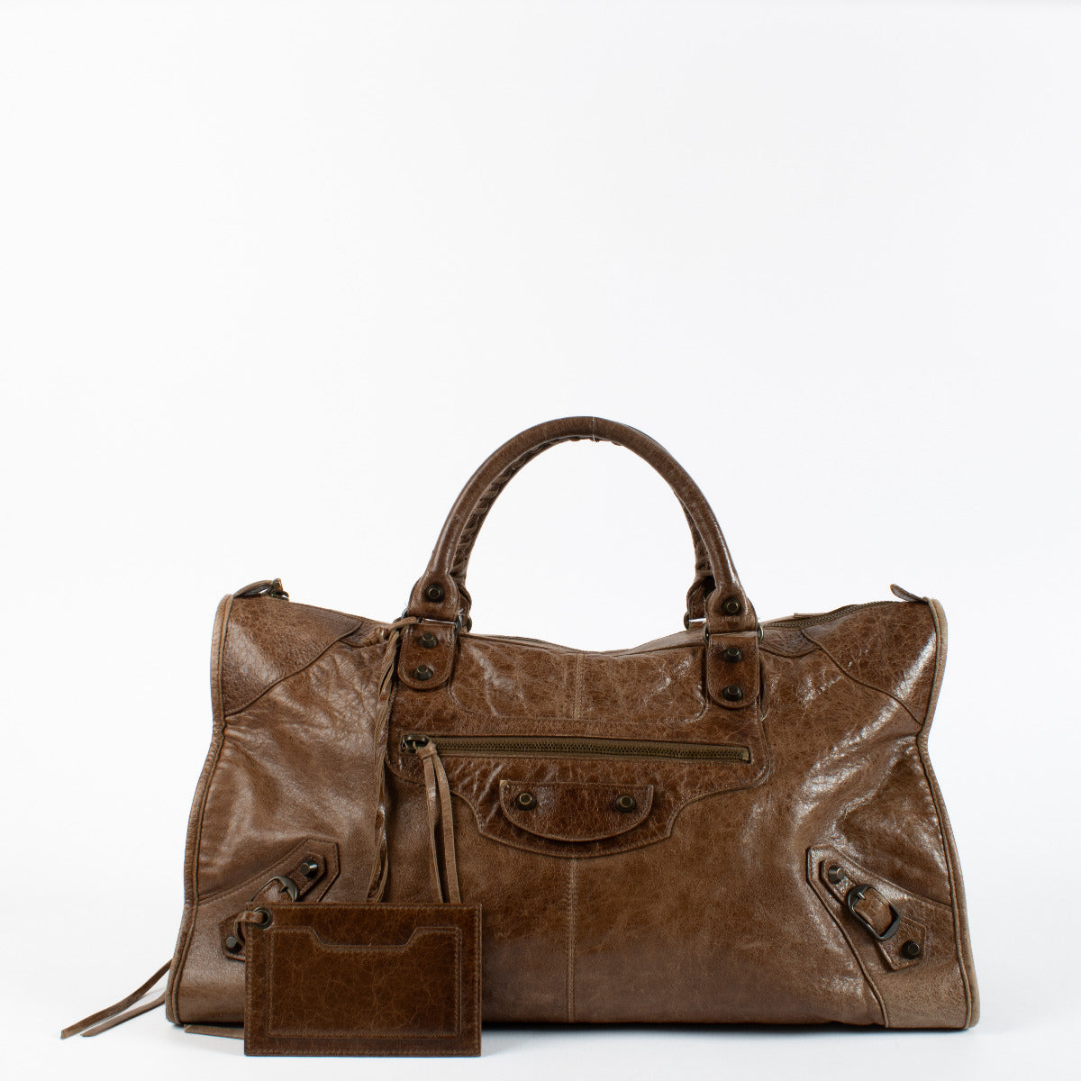 the Brown Leather Work Bag perfectly encapsulates the brand’s effortless fusion of edge and elegance. Rendered in distressed brown Arena leather, this spacious tote boasts the signature slouchy silhouette and hallmark motocross-inspired hardware that made