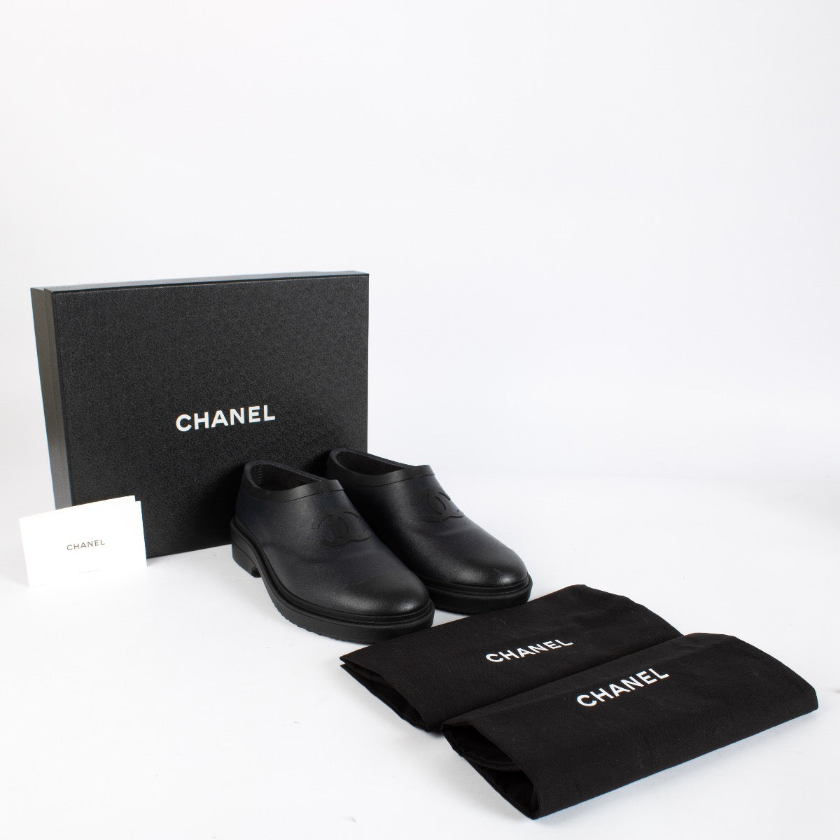 Authentic pre-loved Chanel Black Coco Mark Rubber Slip-On Shoes — Size 39 on Labellov.com