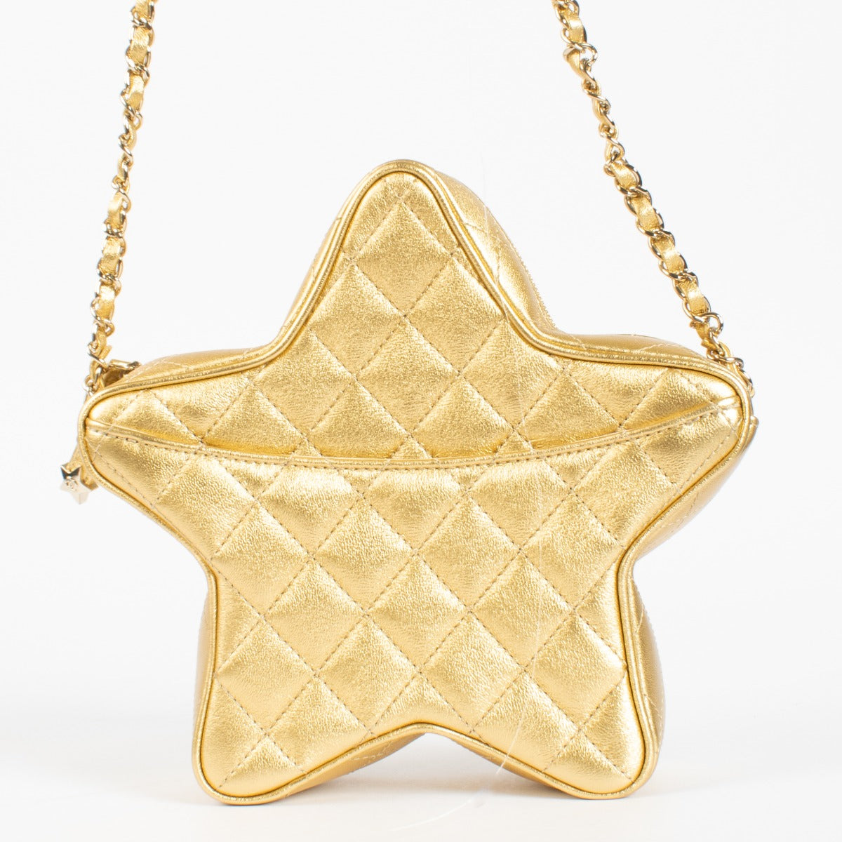 Authentic pre-loved Chanel Metallic Gold Leather Star Bag on Labellov.com