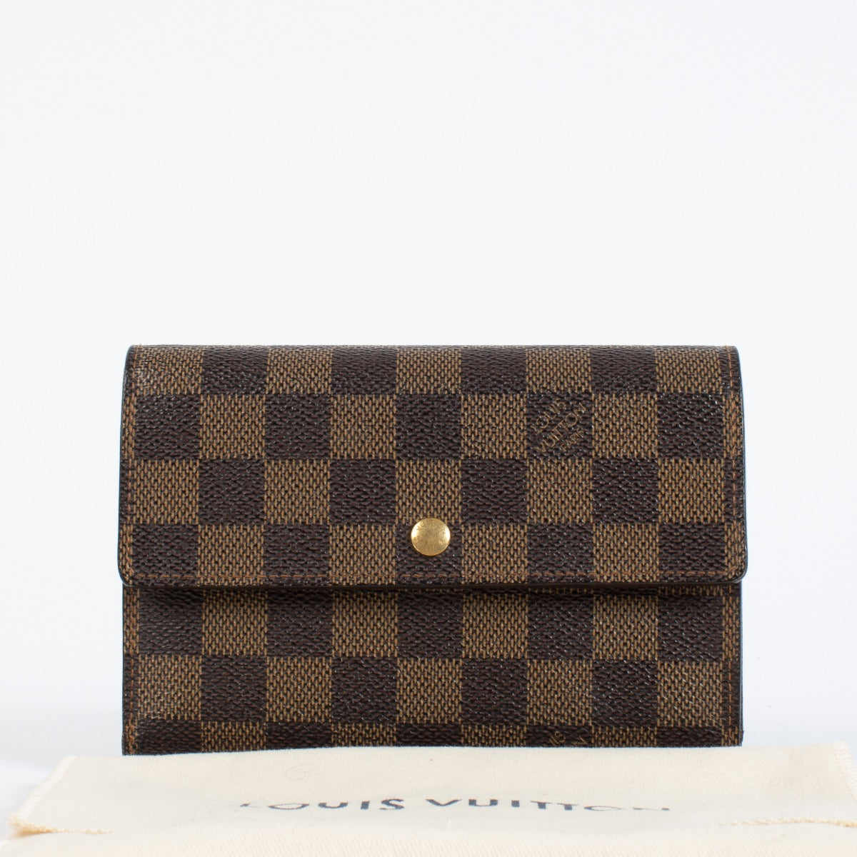 Louis Vuitton Damier Ebene Trésor Wallet in brown checkered canvas with gold-tone snap closure and original dust bag at Labellov.com.