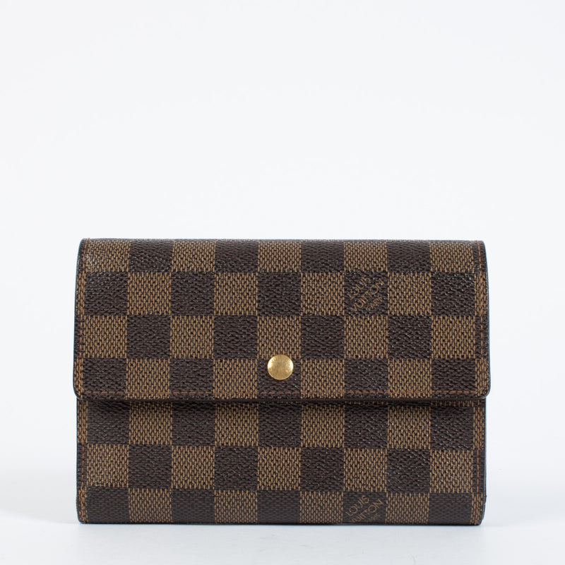 Louis Vuitton Damier Ebene Trésor Wallet in brown checkered canvas with gold-tone snap closure and original dust bag at Labellov.com.