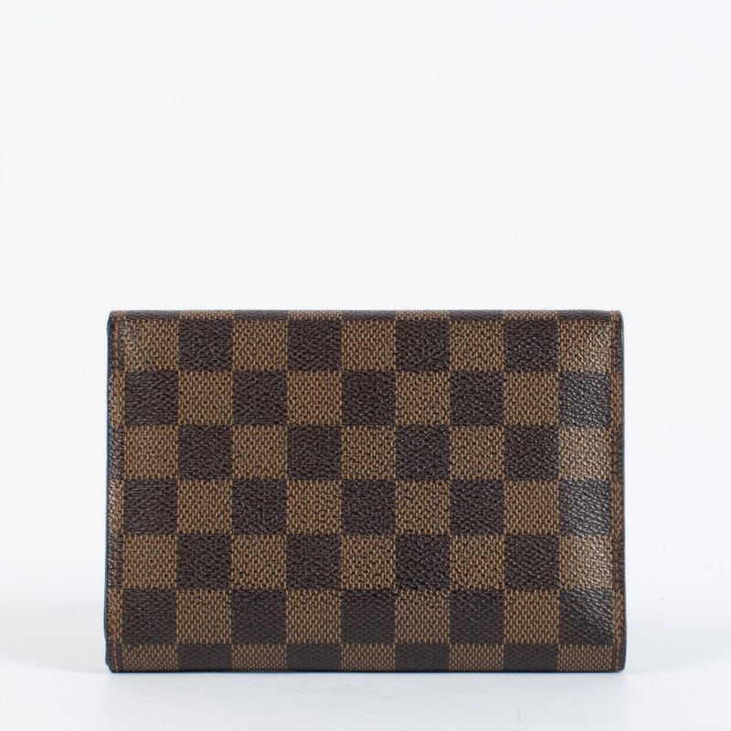 Louis Vuitton Damier Ebene Trésor Wallet in brown checkered canvas with gold-tone snap closure and original dust bag at Labellov.com.