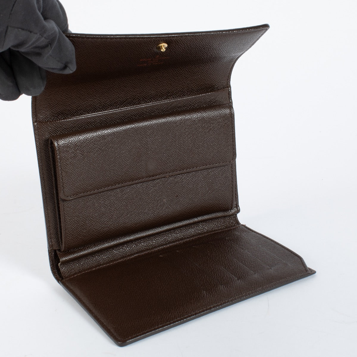 Louis Vuitton Damier Ebene Trésor Wallet in brown checkered canvas with gold-tone snap closure and original dust bag at Labellov.com.