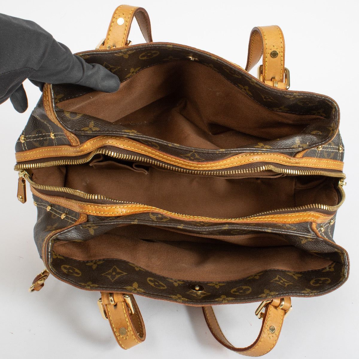 Louis Vuitton Monogram Rivets Handbag with gold rivet detailing and natural leather handles at Labellov.com