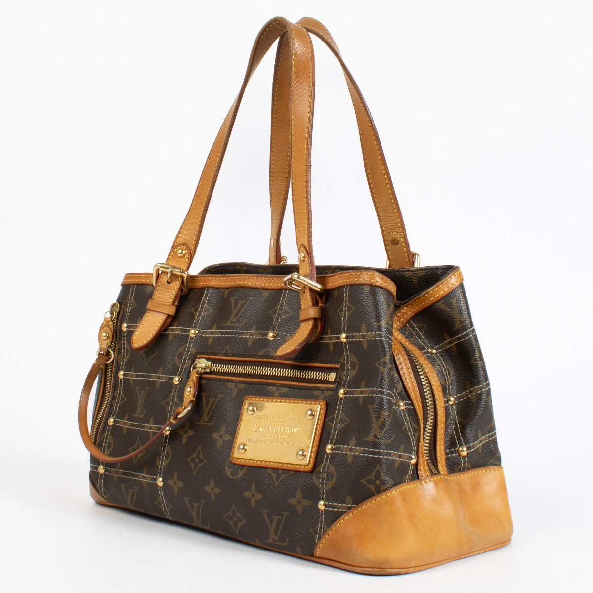 Louis Vuitton Monogram Rivets Handbag with gold rivet detailing and natural leather handles at Labellov.com