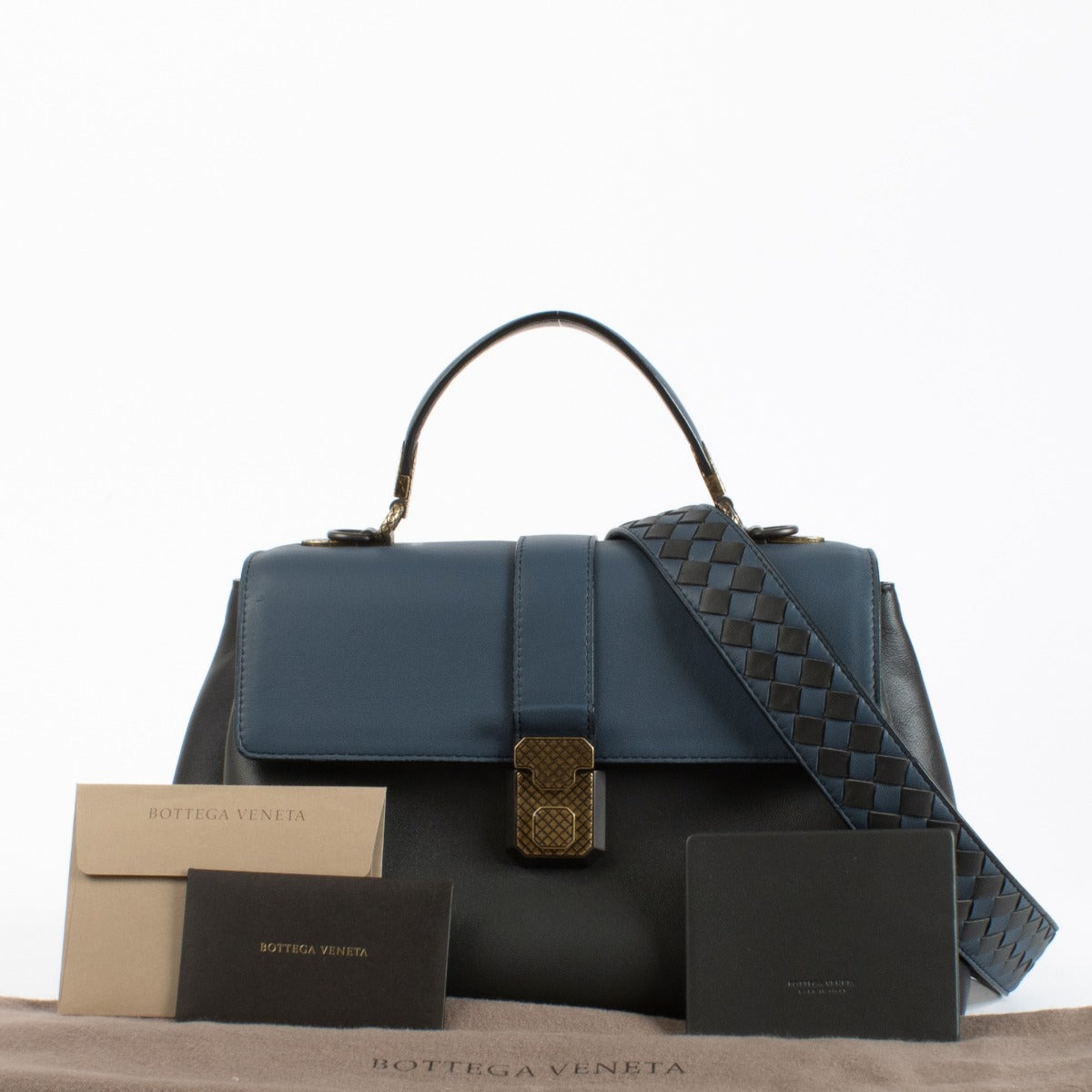 Bottega Veneta Navy Blue Leather Medium Piazza Top Handle Bag with antique gold-tone hardware and woven strap, in very good pre-loved condition, available at Labellov.com