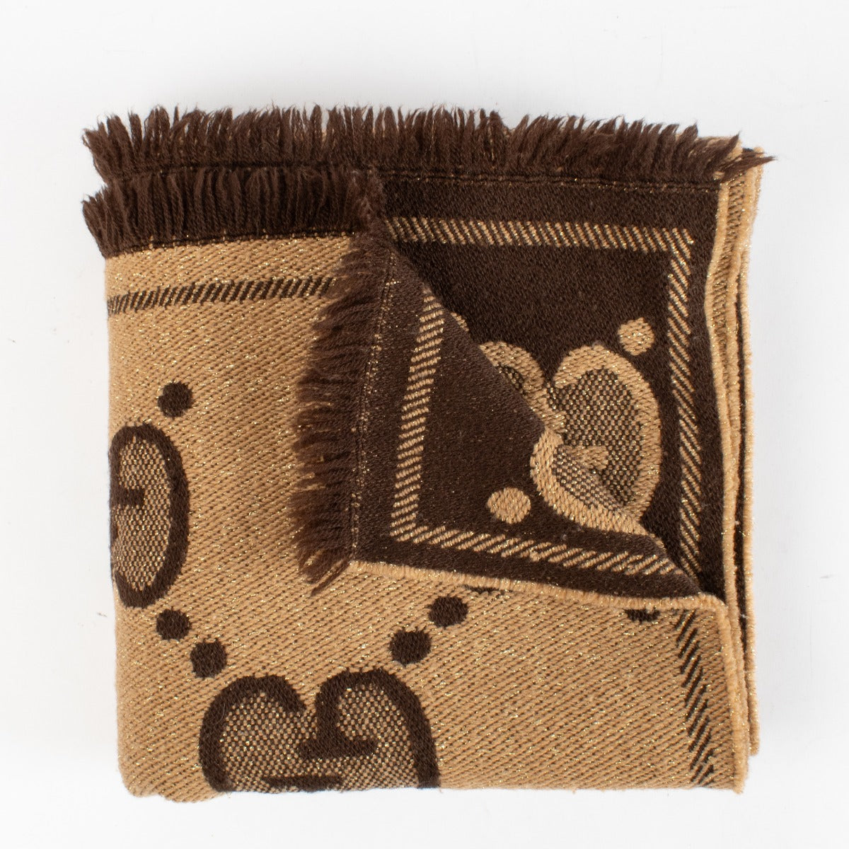 Shop Gucci beige GG lurex wool blend scarf with monogram and gold shimmer. Timeless design and soft texture available now at Labellov.com.