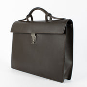 Delvaux brown leather briefcase showing silver-tone combination-lock clasp.