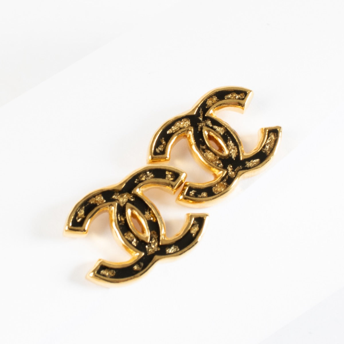 Chanel 23C black and gold CC earrings with gold-fleck enamel detailing at Labellov.com