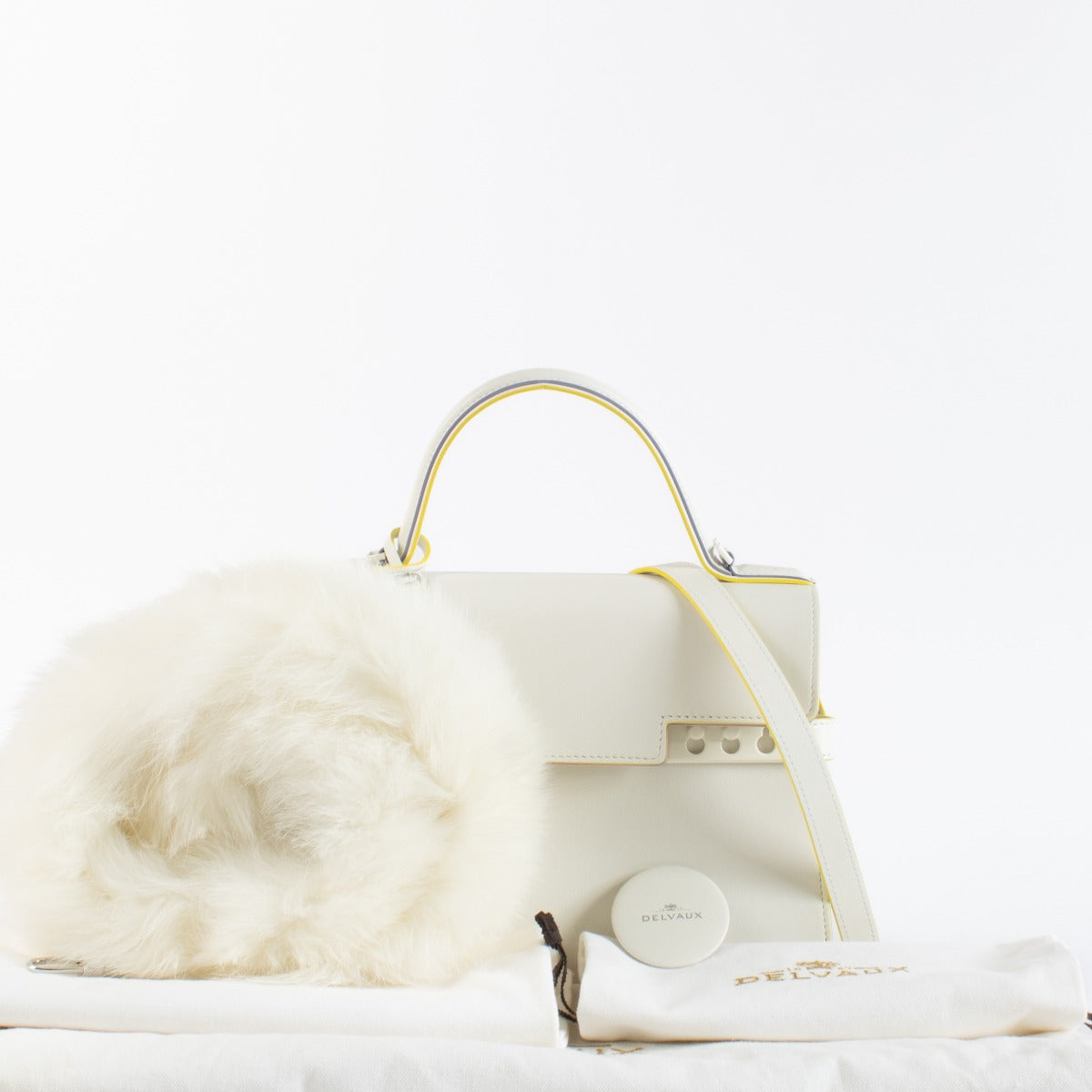 Pre-loved Delvaux Tempête MM Ruban in ivory calfskin with detachable fur strap. A rare, collectible Belgian luxury bag in excellent condition.