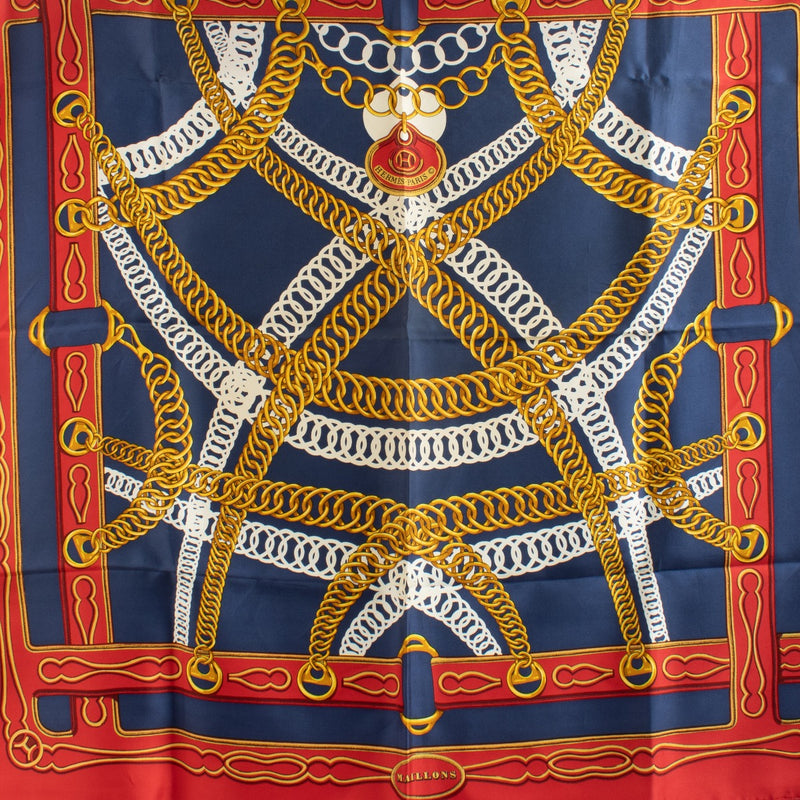 Are you looking for an authentic designer accessory? We buy and sell your preloved and brand new Hermès Red/Blue Maillons 90 Scarf.