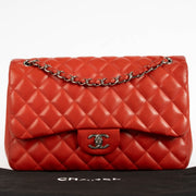 Shop the authentic Chanel Red Lambskin Large / Jumbo Classic Flap Bag second hand on Labellov.com.