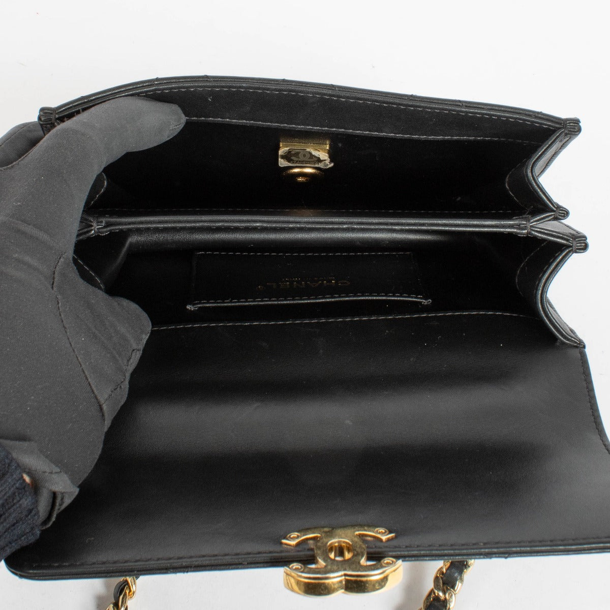 Authentic pre-loved Chanel Black Calfskin Mini Top Handle Flap Bag on Labellov.com