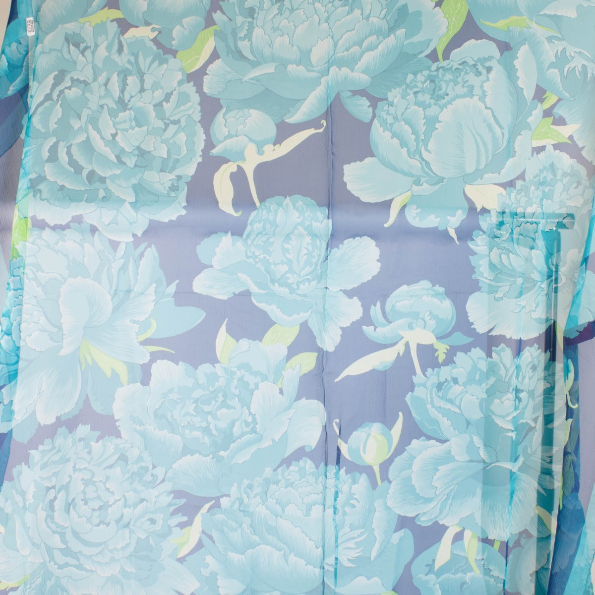Are you looking for an authentic designer accessory? We buy and sell your preloved and brand new Hermès Blue Silk Mousseline Les Pivoines 140 Shawl.