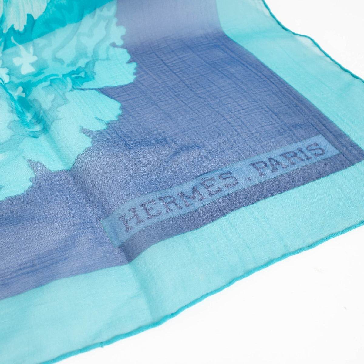 Are you looking for an authentic designer accessory? We buy and sell your preloved and brand new Hermès Blue Silk Mousseline Les Pivoines 140 Shawl.