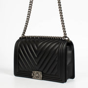 Authentic pre-loved Chanel Black Chevron Calfskin Large Boy Chanel Bag on Labellov.com