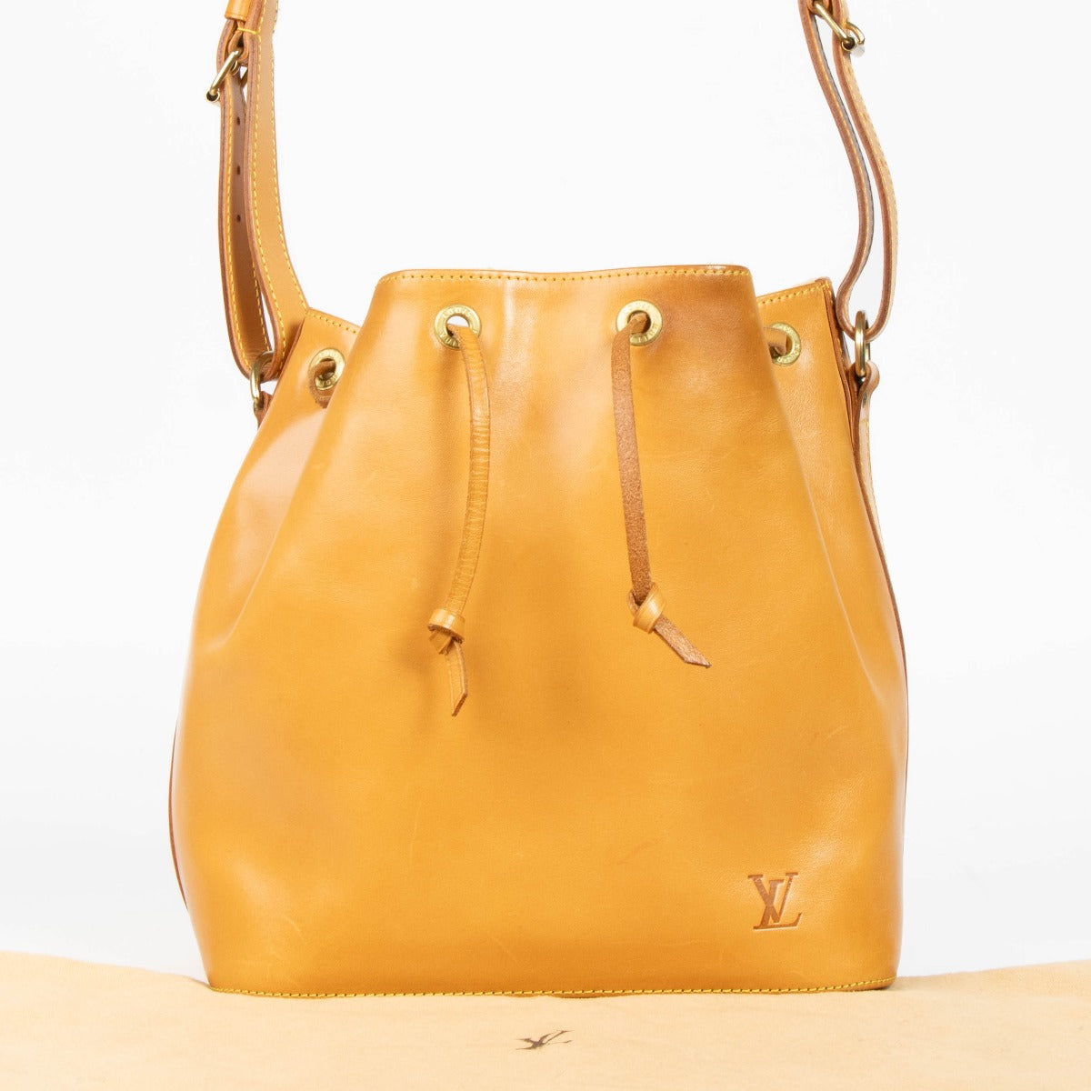 100% authentic second hand Louis Vuitton Nomade Leather Noé Bag with drawstring closure and adjustable shoulder strap.
