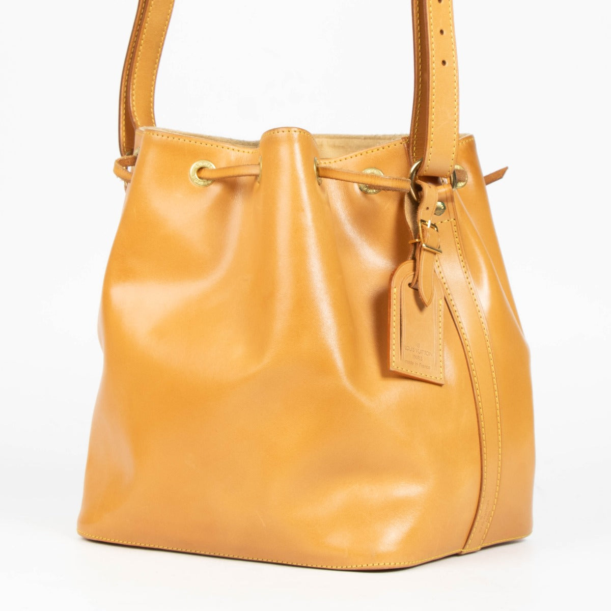 100% authentic second hand Louis Vuitton Nomade Leather Noé Bag with drawstring closure and adjustable shoulder strap.