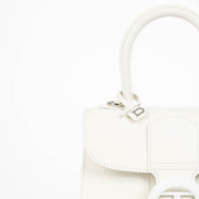 Authentic pre-loved Delvaux Ivory Box Calf Brillant Mini Bag on Labellov.com