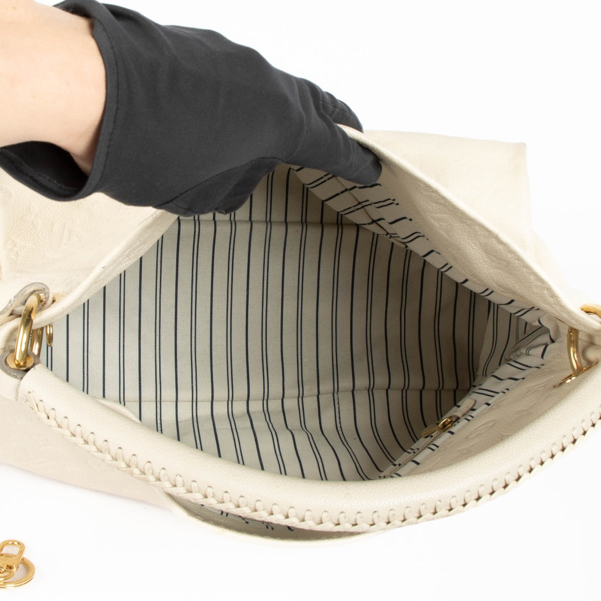 Authentic pre-loved Louis Vuitton White Monogram Empreinte Artsy MM Shoulder Bag on Labellov.com