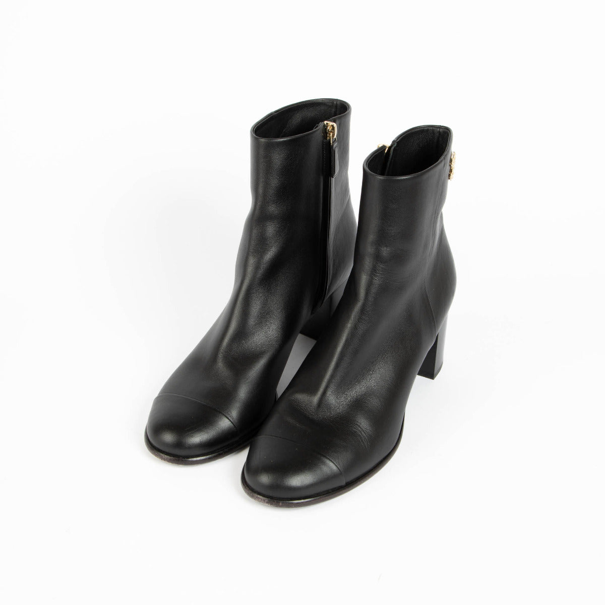 A subtle yet distinctive CC logo detail at the ankle lends a discreet statement of heritage, while the clean lines and minimal design make these boots endlessly versatile. Whether paired with tailored trousers, denim, or fluid dresses, they offer a polish