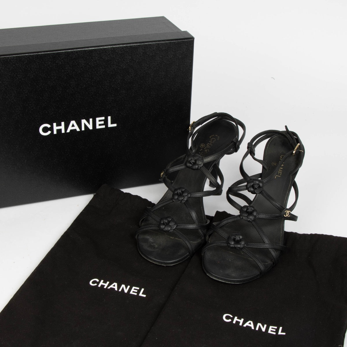 Authentic pre-loved Chanel Black Camellia Sandals - Size 38.5 on Labellov.com