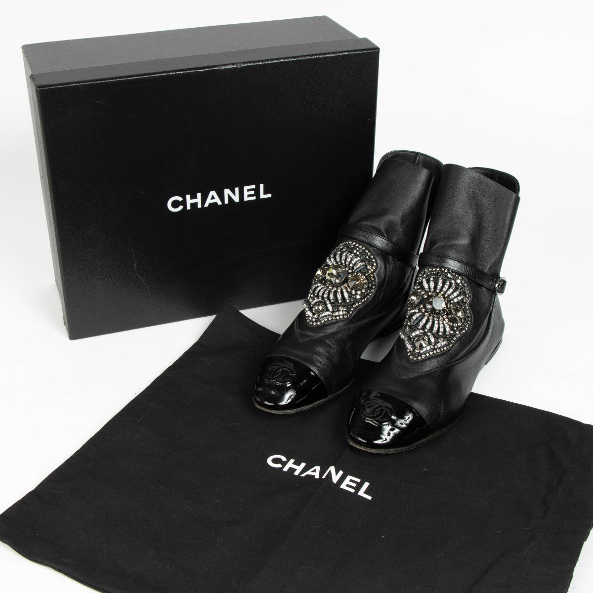 100% authentic second hand Chanel Black Crystal Embellished CC Cap Toe Boots in size 38 at Labellov.