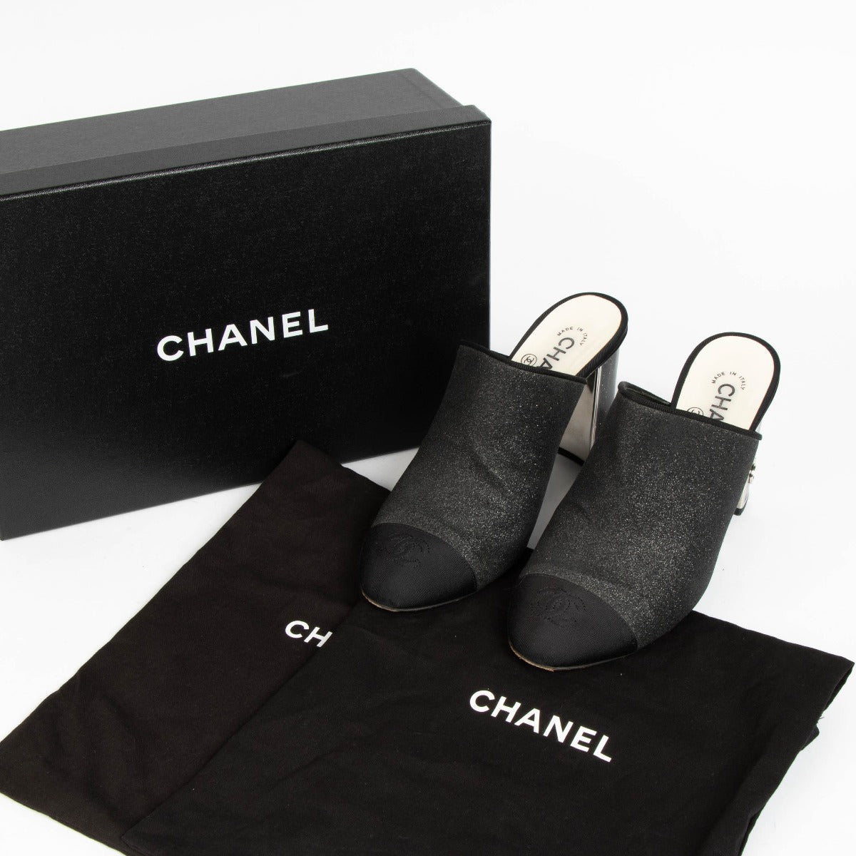 100% authentic Chanel Black Glitter Cap Toe Mules in size 39 with subtle glitter finish and iconic cap toe design.