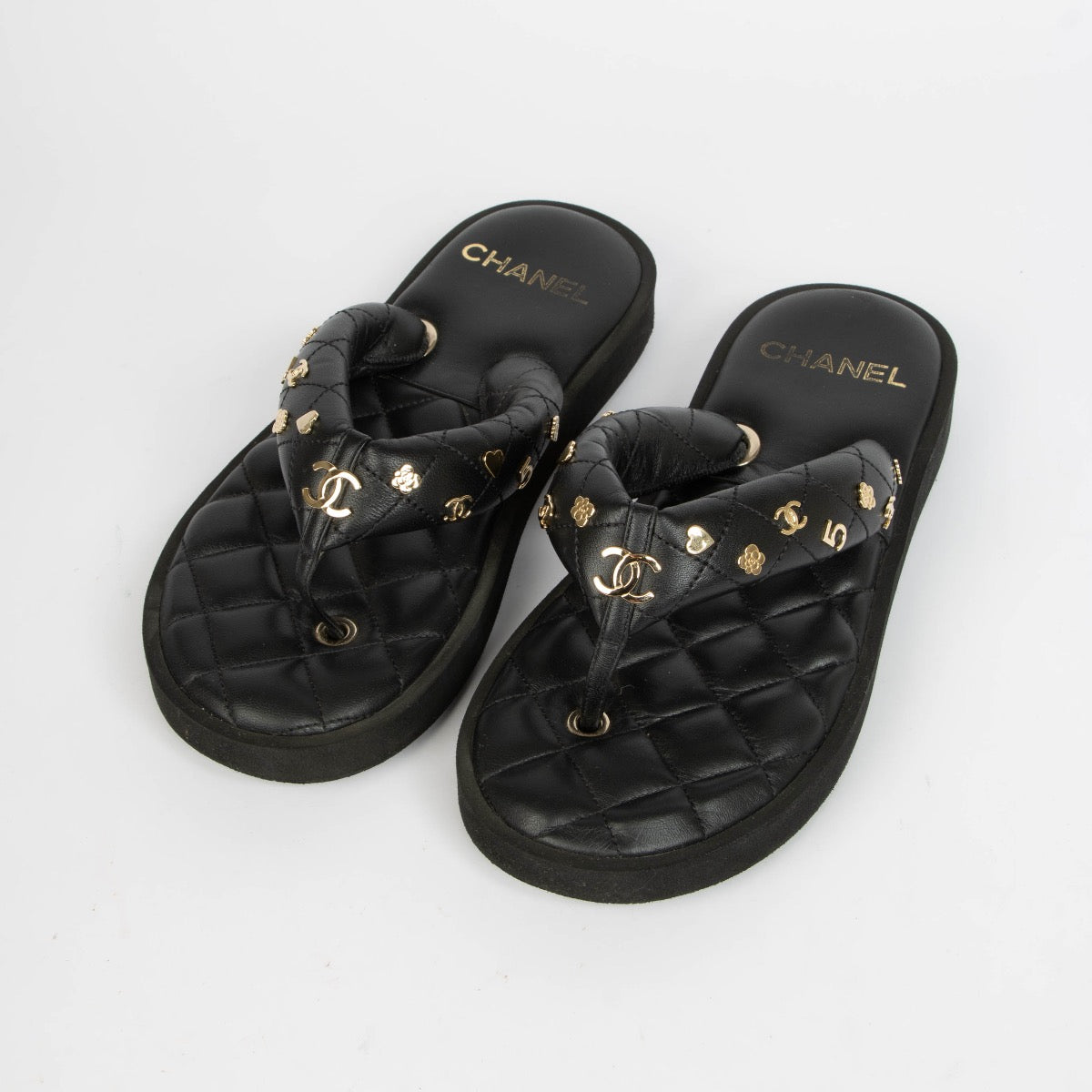 Authentic pre-loved Chanel Black Quilted Charms Thong Sandals -Size 38.5 on Labellov.com