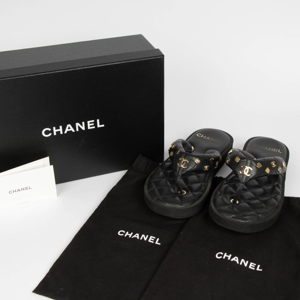 Authentic pre-loved Chanel Black Quilted Charms Thong Sandals -Size 38.5 on Labellov.com