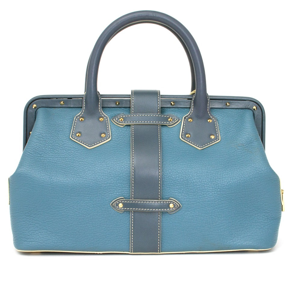 Authentieke Louis Vuitton l'ingenieux blauw dokterstas voor de juiste prijs bij LabelLOV vintage webshop. Louis Vuitton Suhali L'ingenieux bicolor blue shoulder bag.Veilig online winkelen. Luxe, vintage, mode. Antwerpen, België.