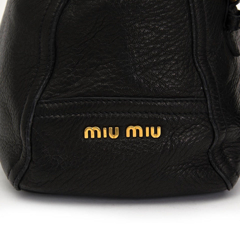 Buy Miu Miu black top handle bag with gold toned hardware at the right price at LabelLOV vintage webshop. Luxe, vintage, fashion. Safe and secure online shopping. Antwerp, Belgium.