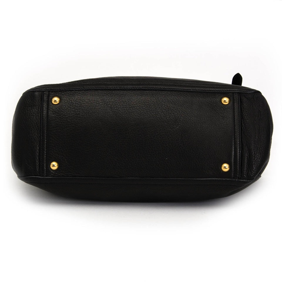 Buy Miu Miu black top handle bag with gold toned hardware at the right price at LabelLOV vintage webshop. Luxe, vintage, fashion. Safe and secure online shopping. Antwerp, Belgium.