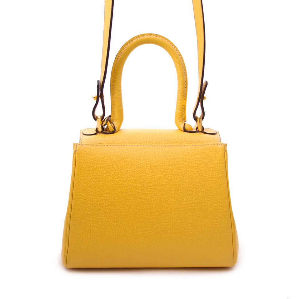Stunning musthave it-bag Delvaux Brillant Yellow Mini + Strap for sale, luxury and designer items at affordable prices.