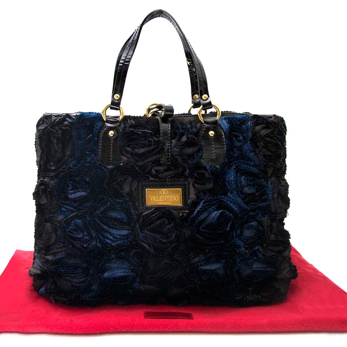 Compra une cartera Valentino autentica vintage en el color negro y azul muy en moda para el precio correcto en LabelLOV.