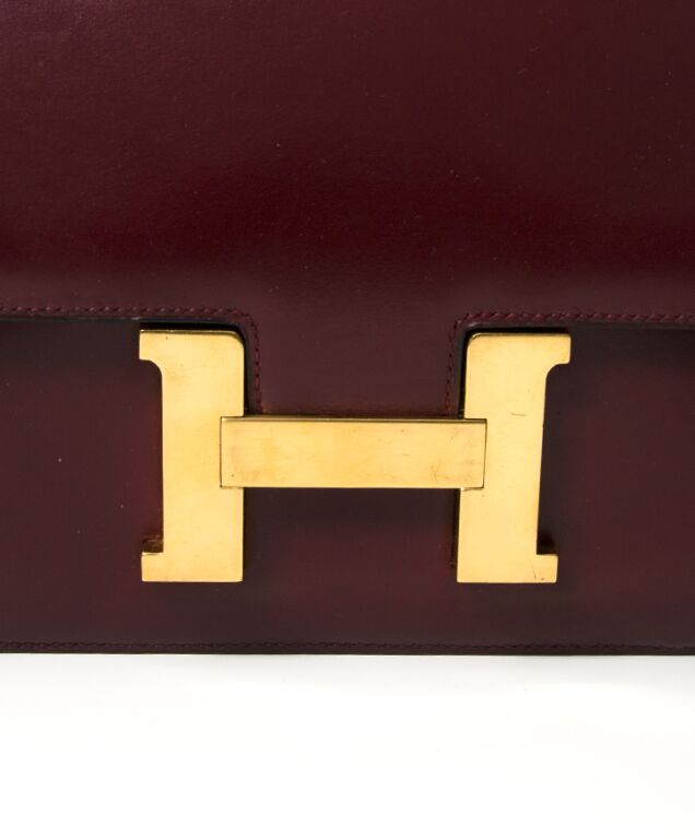 Sold at Auction: A Vintage Hermes Constance Handbag. Burgundy red crocodile  leather. Gilded hardware with letter H clasp. Interior zipped compartment.  In good condition but some slight markings on inner flap. Ref