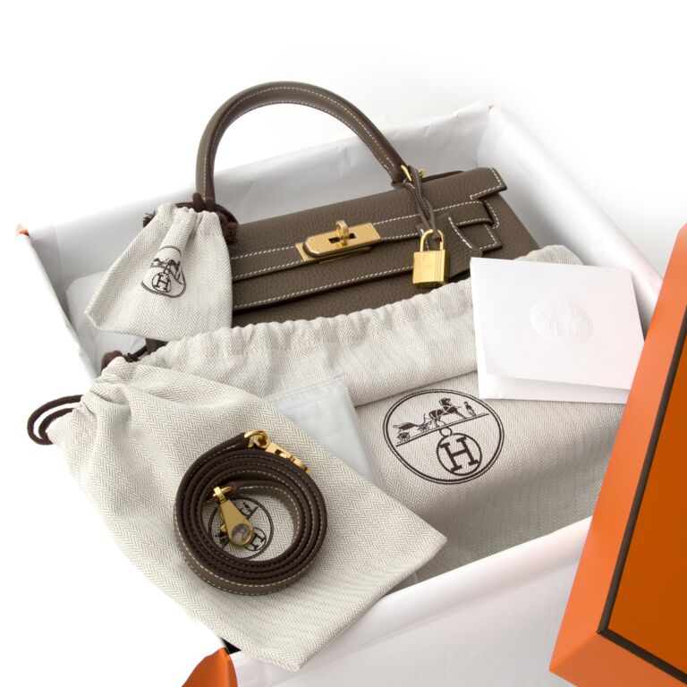 HERMÈS, ETOUPE RETOURNE KELLY 32CM OF TAURILLON CLEMENCE LEATHER WITH GOLD  HARDWARE, Handbags & Accessories, 2020